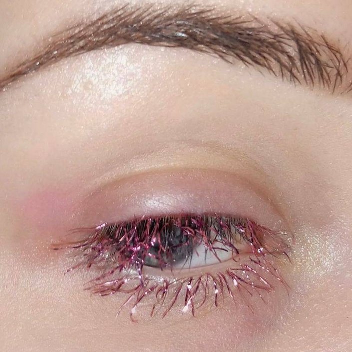 pink tinsels glued on eyelashes