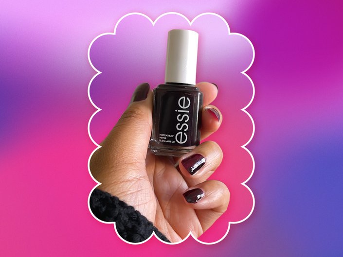 Photo of a hand with painted nails holding up Essie Wicked, collaged on a pink and purple graphic background