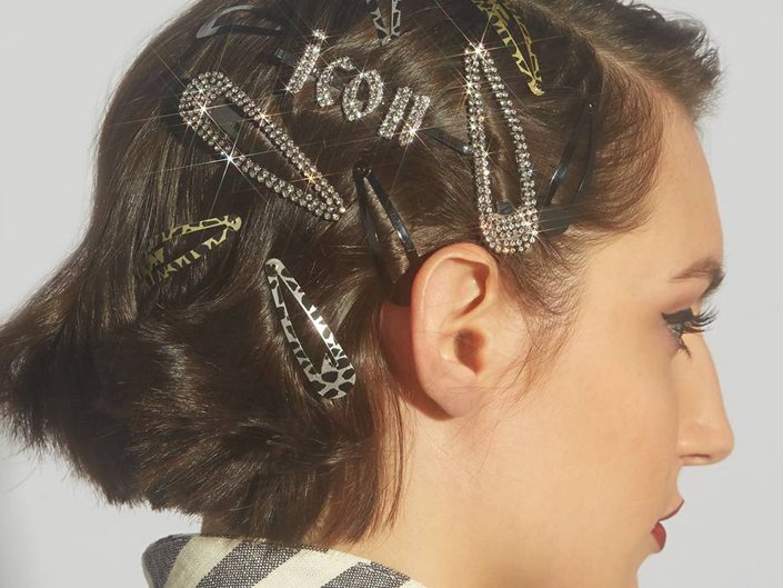 person wearing multiple hair clip accessories in hair