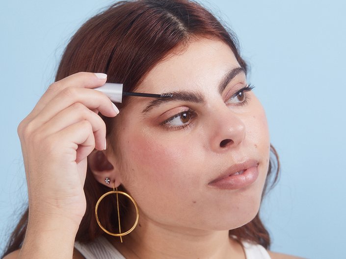 Person applying brow gel to their eyebrow
