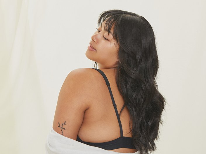 Image of woman with wavy black hair and bangs