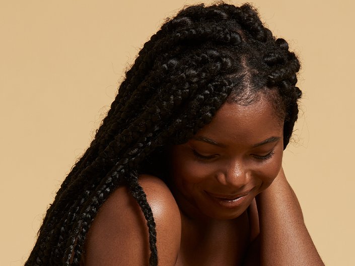 Picture of a model wearing twists and smiling